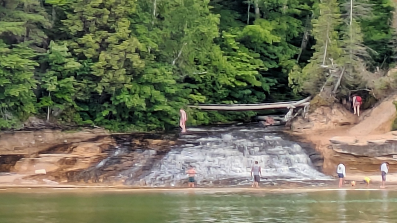 Hikers Enjoy Swimming at Waterfall