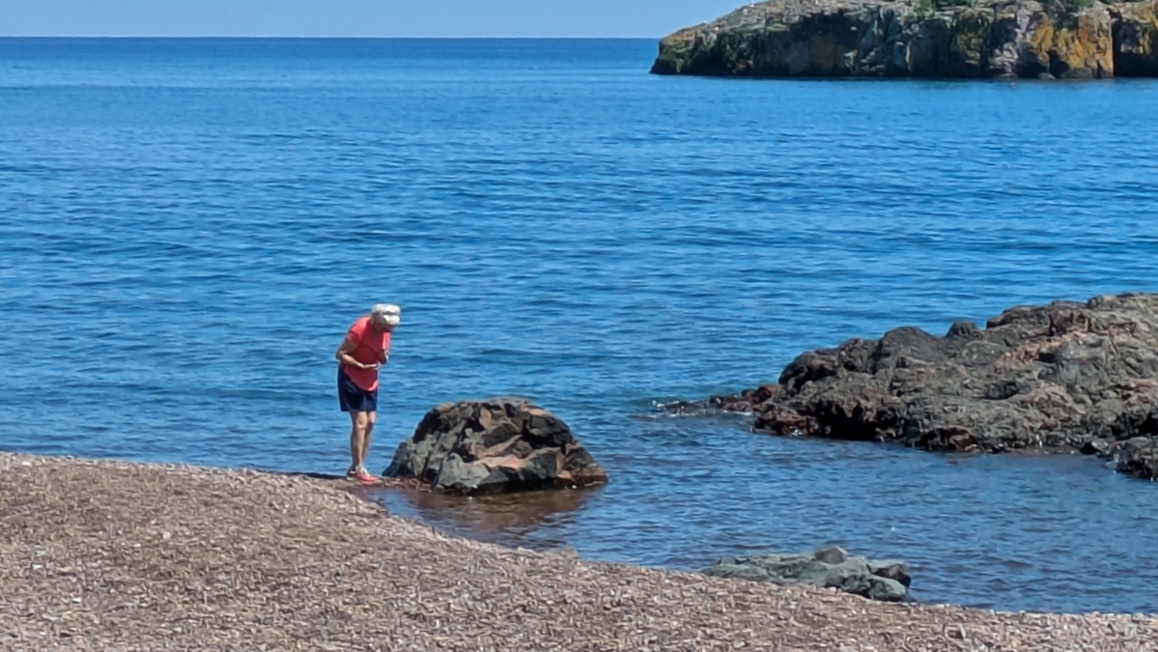 Sandy Looks for Interesting Stones on Pebble Beach