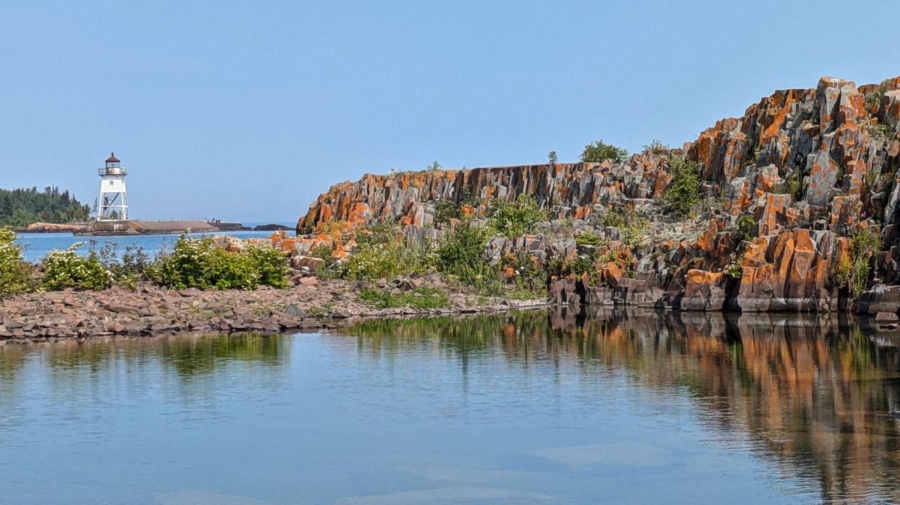 Red Rock Shore Frames Harbor Entrance