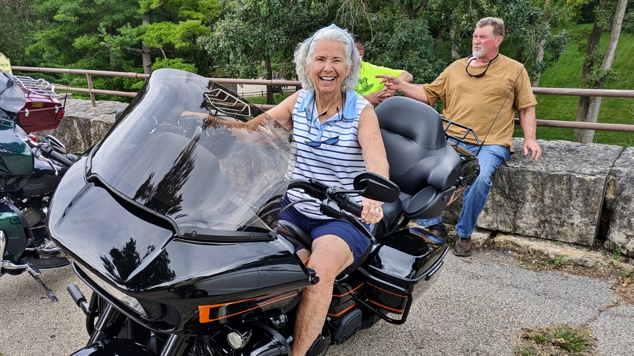 Sandy Tries Out a Harley Belonging to Fellow Grant Home Tourist