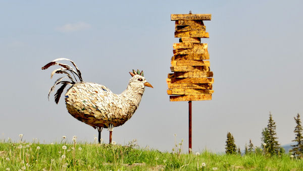 Eggee, the Giant Chicken Sculpture, Stands Next to All-Around-the-World Signpost